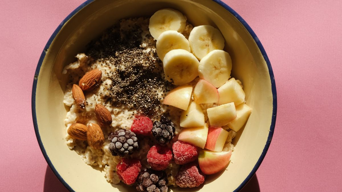 A bowl of oatmeal topped with fresh fruit, nuts, and seeds, a high-fiber breakfast