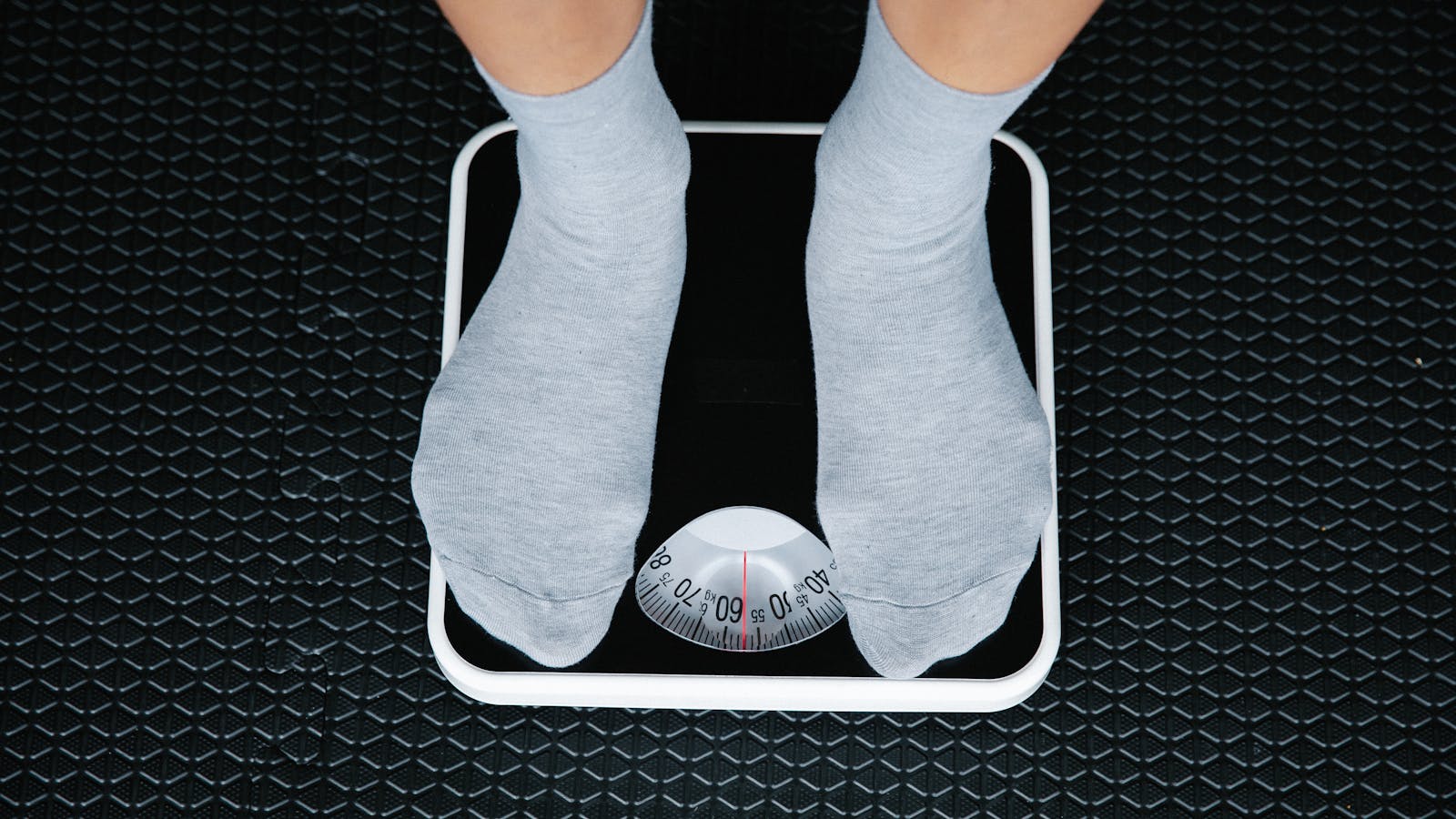 Top-down view of feet on a digital bathroom scale