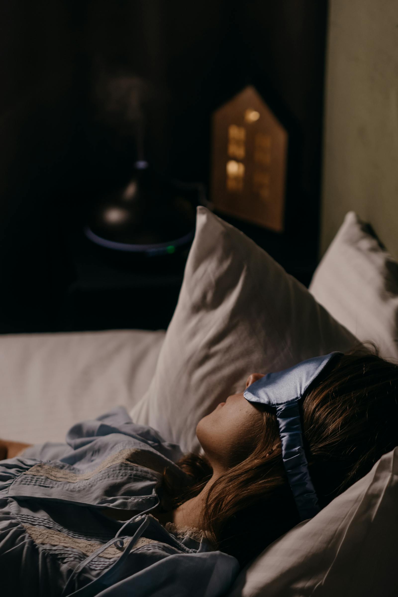 Person sleeping peacefully with a blue eye mask