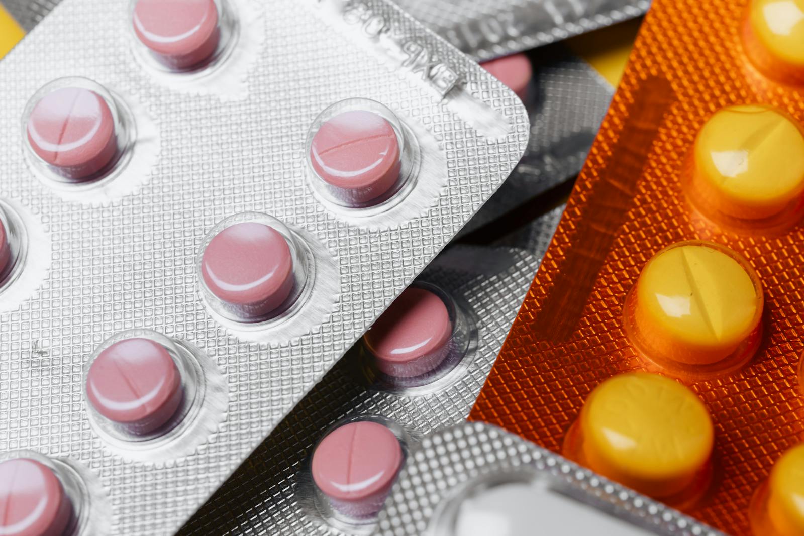 Close-up of colorful pharmaceutical tablets in transparent blister packs