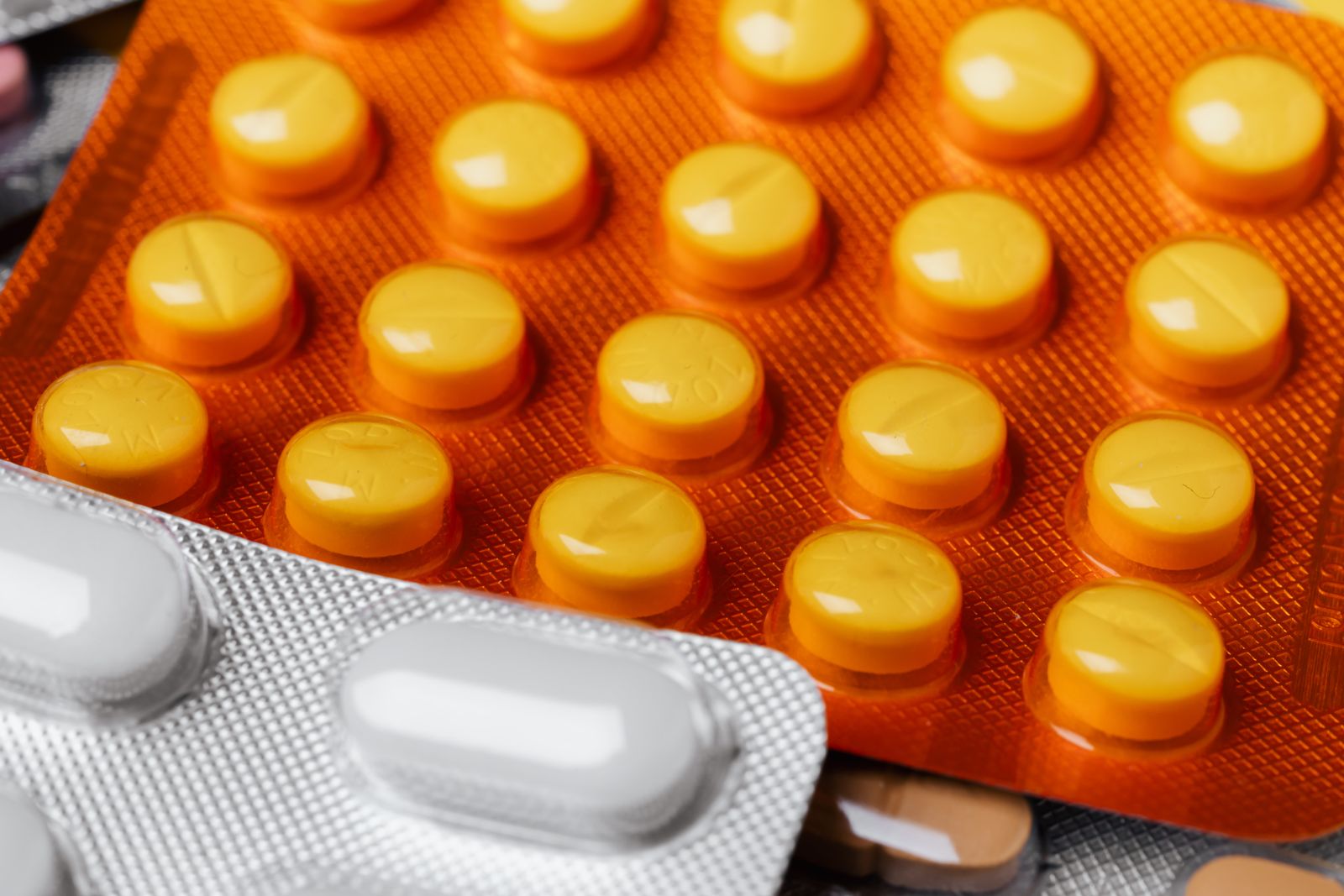 Close-up of foil blister packs of round tablets, the format used for oral contraceptive pills