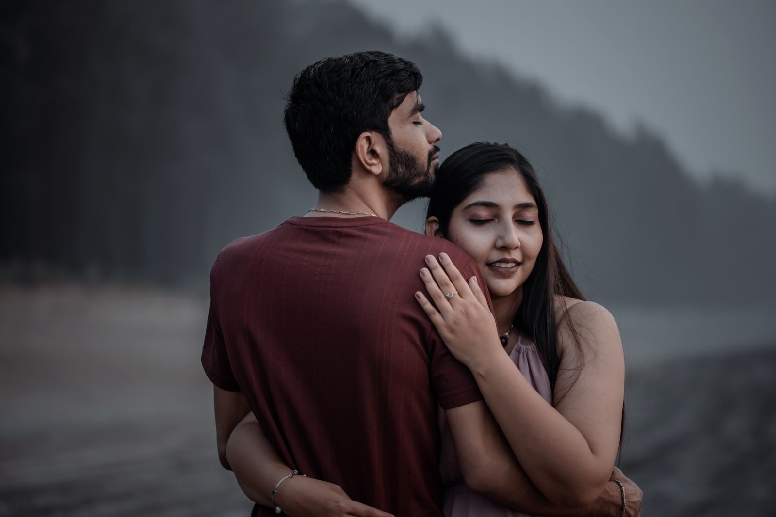 A couple embracing quietly with eyes closed against a soft misty backdrop, evoking desire and intimacy, the low-libido problem PT-141 is used for