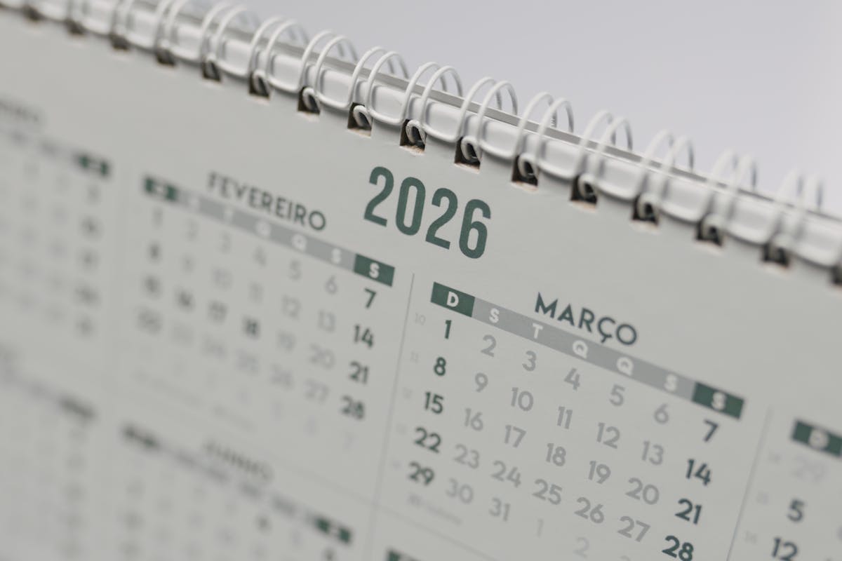 Close-up of a spiral-bound 2026 desk calendar showing the month grids