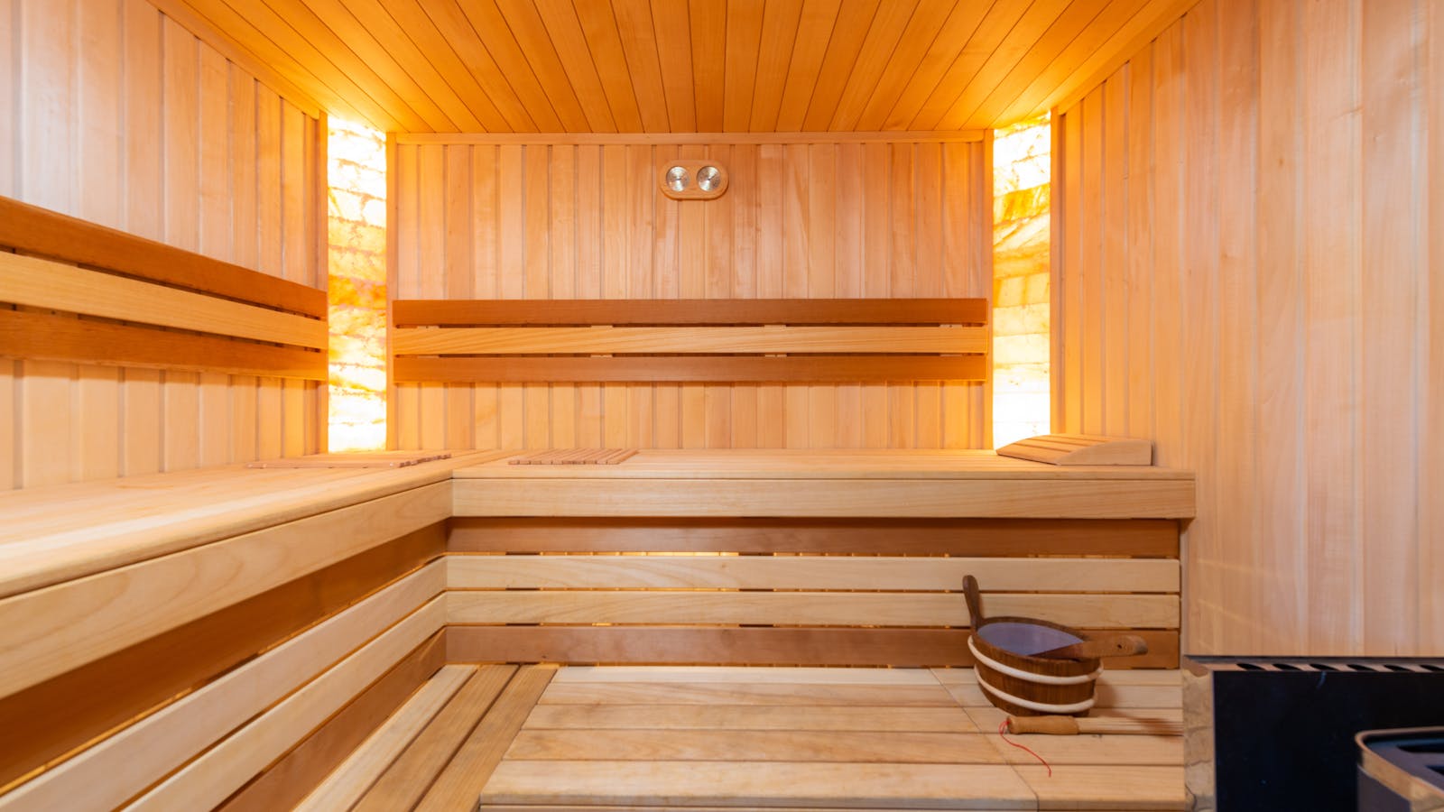 Empty wooden Finnish sauna interior with warm lighting